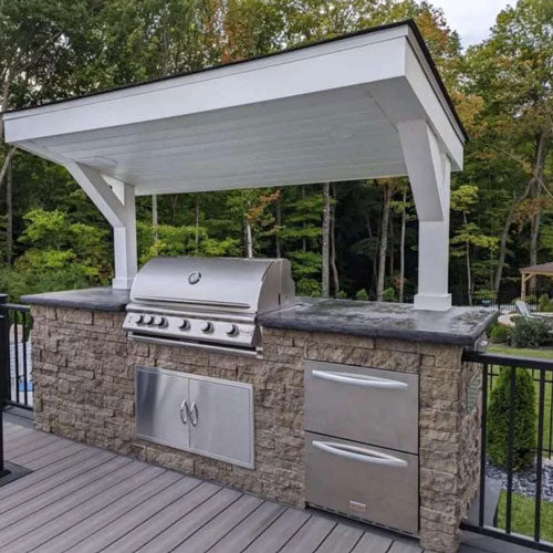 under cover outdoor grill area with stone siding Evolve Stone morning aspen color