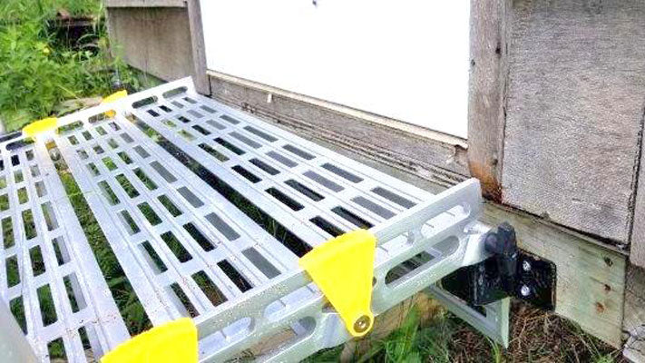 aluminum portable ramp attached to shed with seg mount brackets