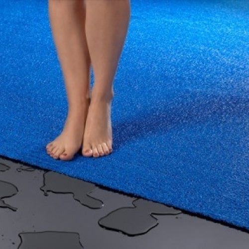 feet on a blue vinyl loop mesh pool mat rug