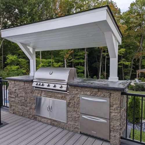 under cover outdoor grill area with stone siding Evolve Stone morning aspen color 