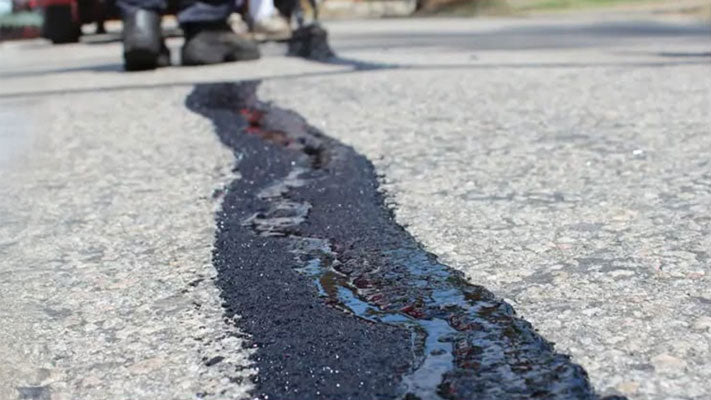 Bitumastic coal tar epoxy coating applied on a road crack