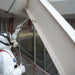 man applying Carbocrylic 3359 topcoat finish in white to a building exterior