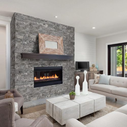 Evolve Stone Fire Rated stone paneling National True Phantom Shadow color around a fireplace