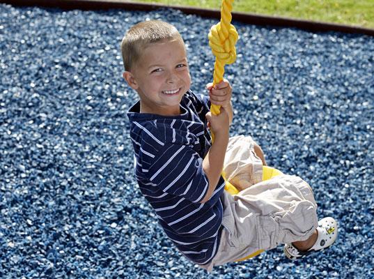 Kid playing in Blue Rubber Mulch