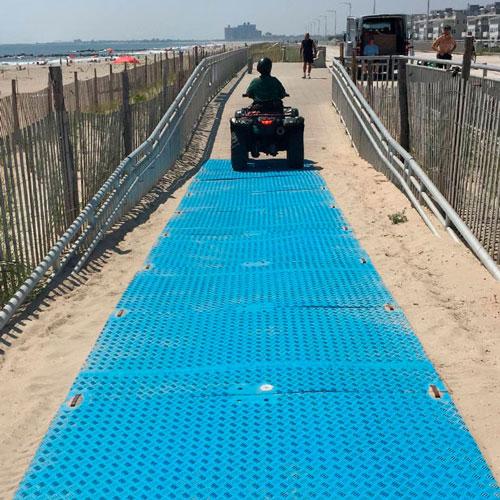 blue beach access mat over sand accessdeck