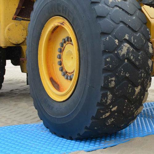 blue ground protection mat under truck tire