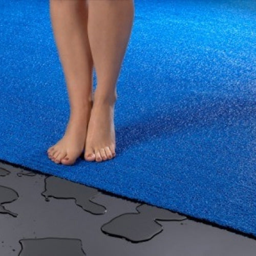 feet on a blue vinyl loop mesh pool mat rug 
