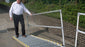 man walking on roll a ramp portable wheelchair ramp