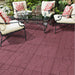 red rubber pavers installed on a backyard patio sitting area