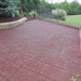 driveway with red rubber pavers installed by gate